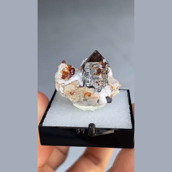 Small smoky quartz with spessartine garnet and hyalite from Yunxiao, Fujian — complete view