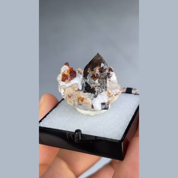 Small smoky quartz with spessartine garnet and hyalite from Yunxiao, Fujian — alternate view