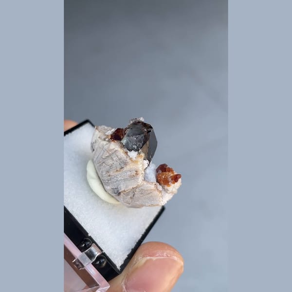 Small smoky quartz with spessartine garnet and hyalite from Yunxiao, Fujian — alternate view