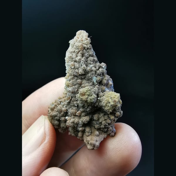 Quartz crystal with red-brown tower-shaped calcite — complete view