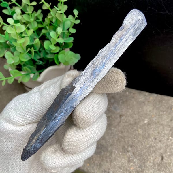 Long steel grey stibnite single crystal — detail view