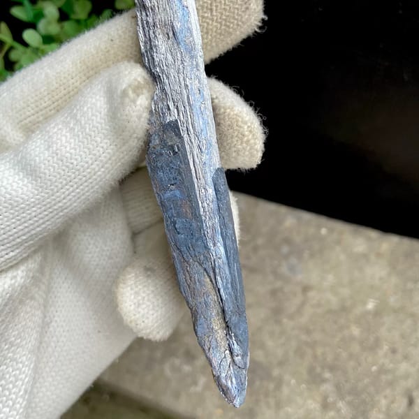 Long steel grey stibnite single crystal — detail view