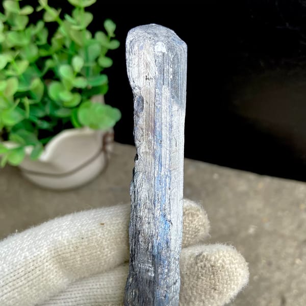 Long steel grey stibnite single crystal — detail view