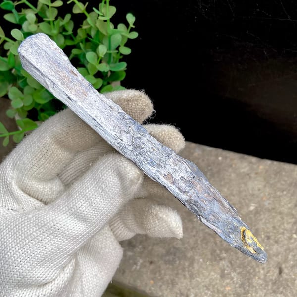 Long steel grey stibnite single crystal — detail view