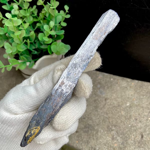 Long steel grey stibnite single crystal — detail view