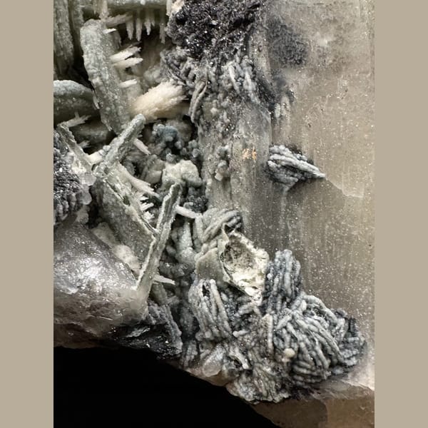 Quartz with green calcite, dogtooth calcite and specular hematite from Inner Mongolia — detail view