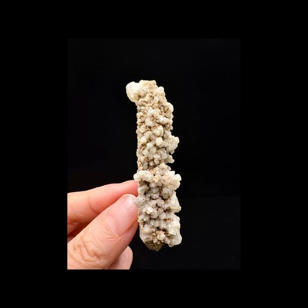 Double-terminated quartz with calcite from Inner Mongolia — complete calcite-covered front view