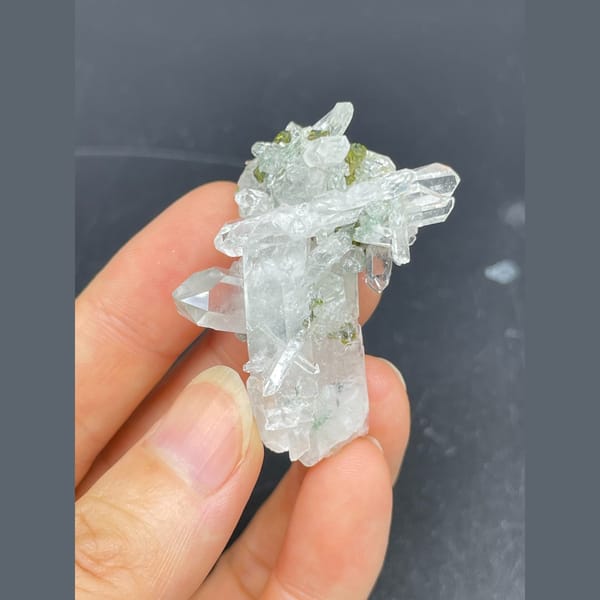 Clear quartz crystals with green epidote from Meigu — complete view