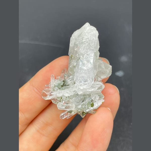 Clear quartz crystals with green epidote from Meigu — alternate view