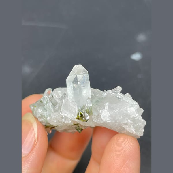 Clear quartz crystals with green epidote from Meigu — detail view