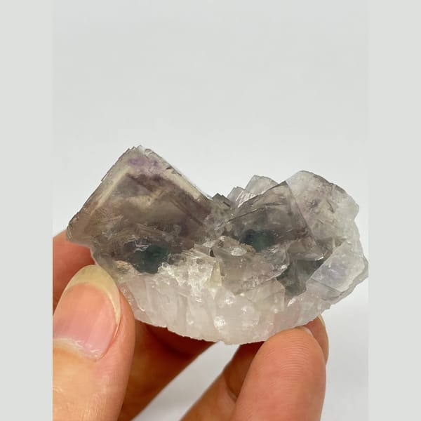Translucent smoky grey-purple fluorite with two joined crystals from Zhejiang — complete view
