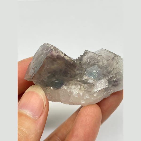 Translucent smoky grey-purple fluorite with two joined crystals from Zhejiang — detail view