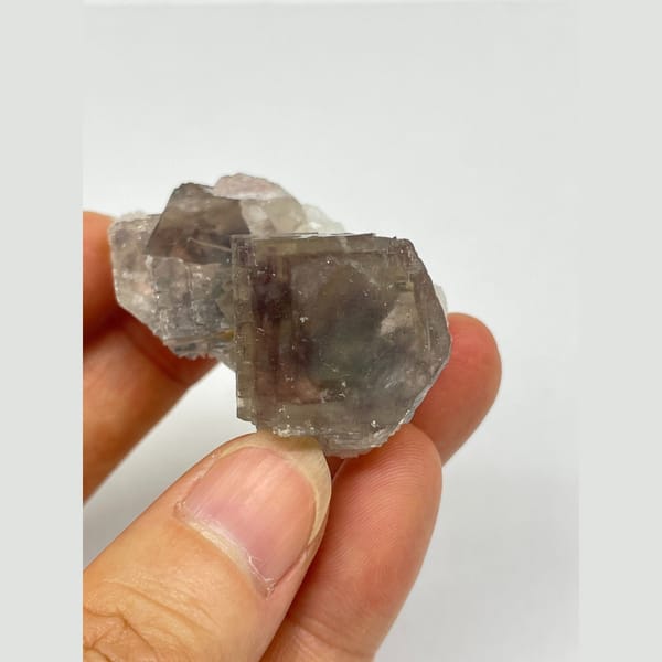 Translucent smoky grey-purple fluorite with two joined crystals from Zhejiang — detail view
