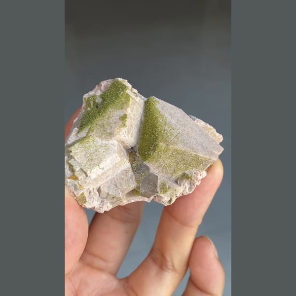 Fuzzy moss-green epidote on pale blocky crystals with chabazite from Yunxiao, Fujian — detail view