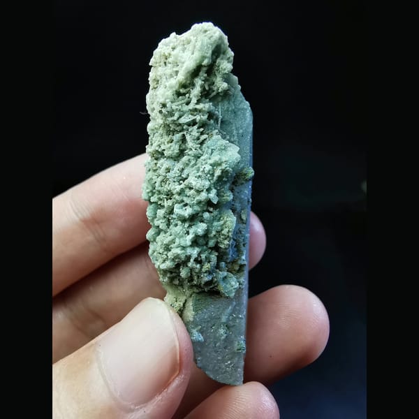 Quartz crystal with a burst of green calcite — alternate view