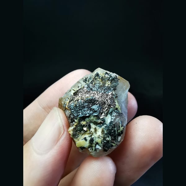 Calcite crystal with pyrite and hematite at the base — alternate view