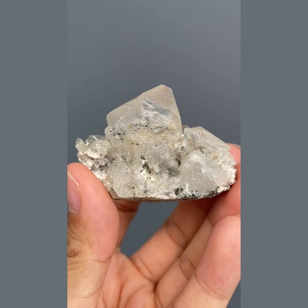 Colourless fluorite crystal on a sparkling matrix from Inner Mongolia — alternate view