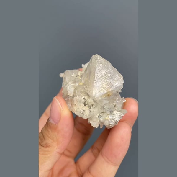 Colourless fluorite crystal on a sparkling matrix from Inner Mongolia — alternate view