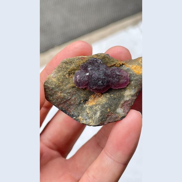 Deep purple fluorite crystals on dark matrix from Henan — complete view