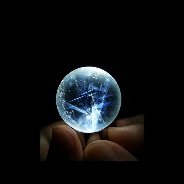 Clear quartz sphere full of feathery blue needles — alternate view