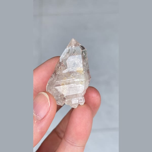 Small clear quartz crystal with inclusions from Yunnan — complete view