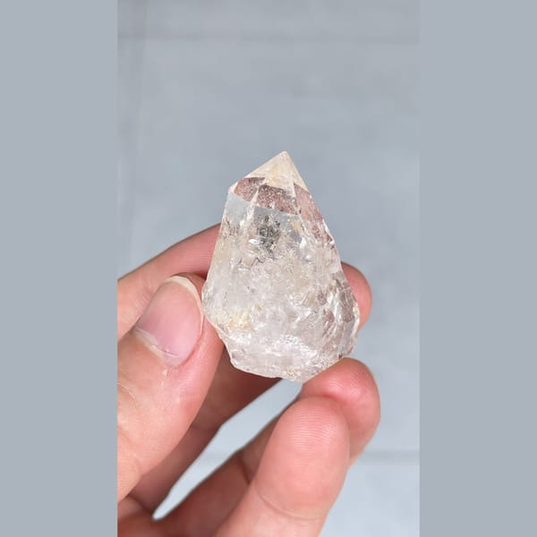 Small clear quartz crystal with inclusions from Yunnan — alternate view