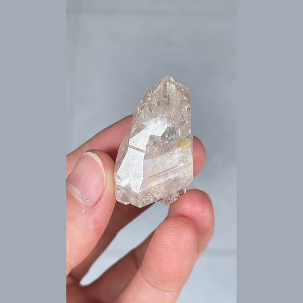 Small clear quartz crystal with inclusions from Yunnan — alternate view