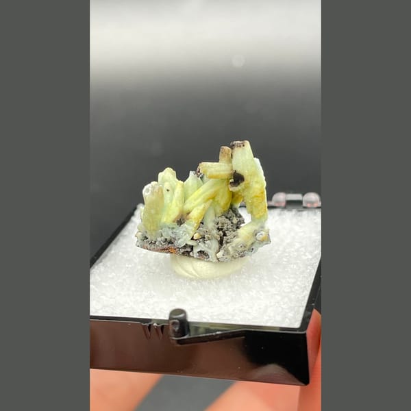 Yellow-green plumbogummite crystals on dark matrix from Guangxi — alternate view