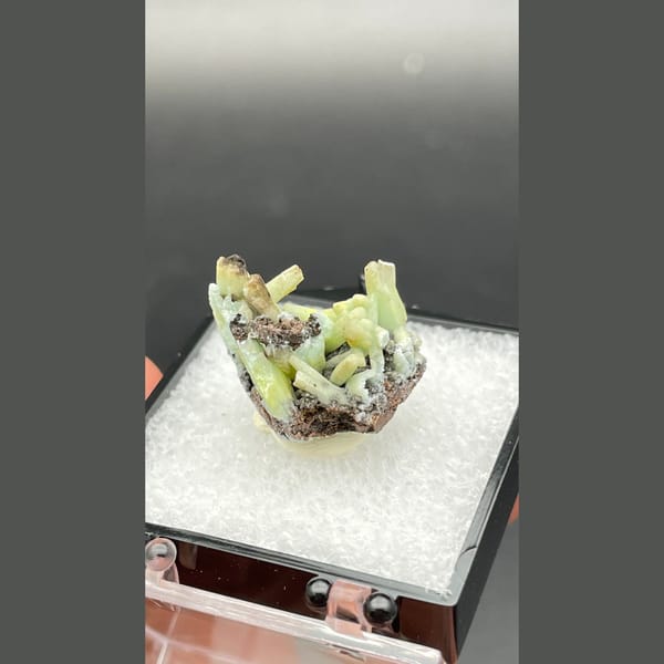 Yellow-green plumbogummite crystals on dark matrix from Guangxi — alternate view