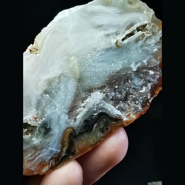 Red and white Brazilian agate geode with lid — detail view