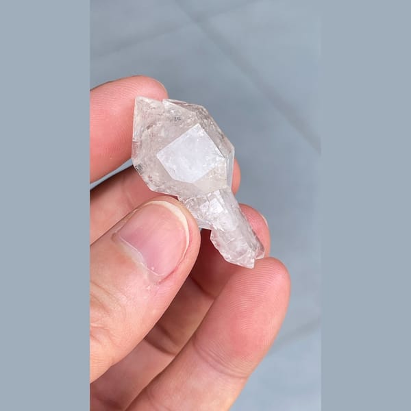 Clear quartz crystal with an unusual irregular form from Yunnan — alternate view