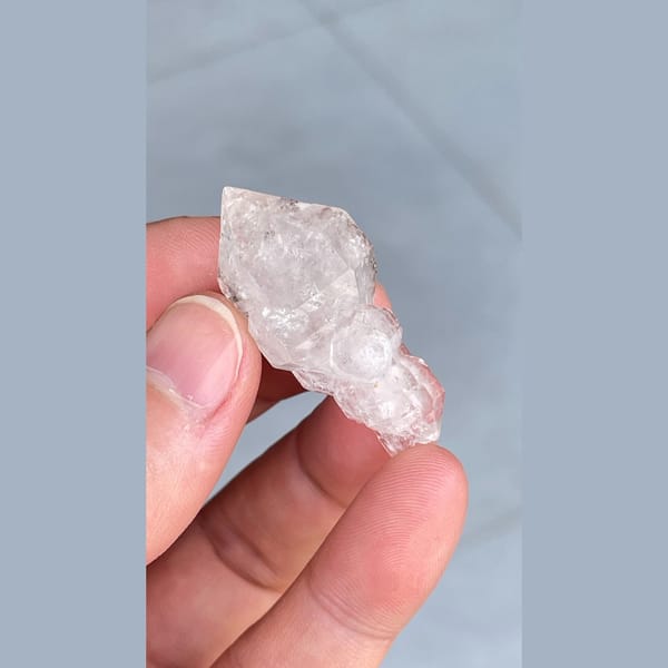 Clear quartz crystal with an unusual irregular form from Yunnan — alternate view