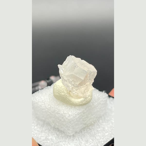Tiny colourless fluorite crystal with mica from Pakistan — alternate view