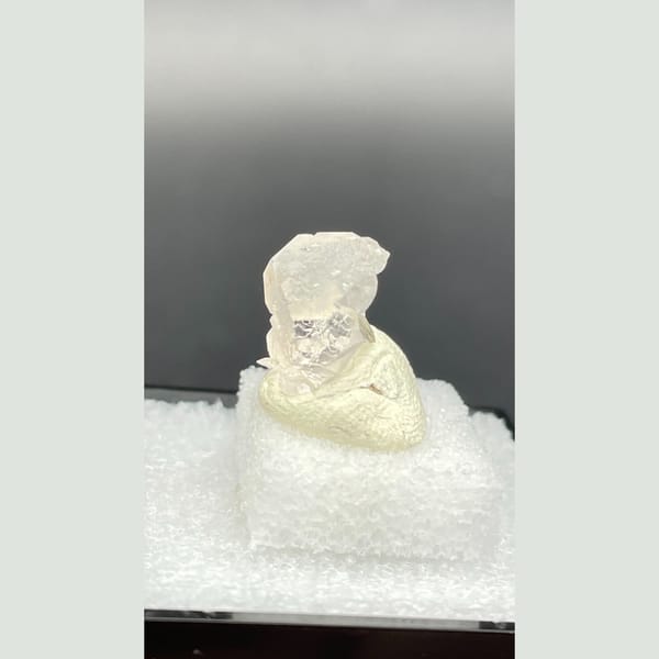 Tiny colourless fluorite crystal with mica from Pakistan — alternate view