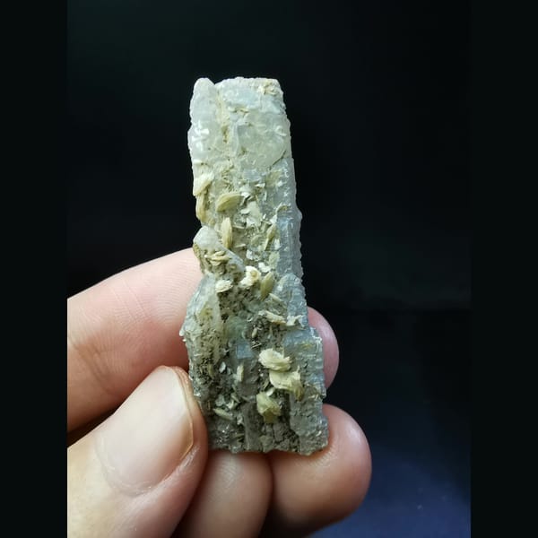 Flat quartz crystal with yellow calcite plates — complete view