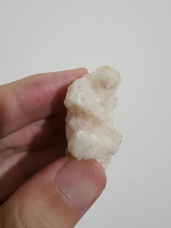 Pale pink calcite floater cluster, crystal-plate view