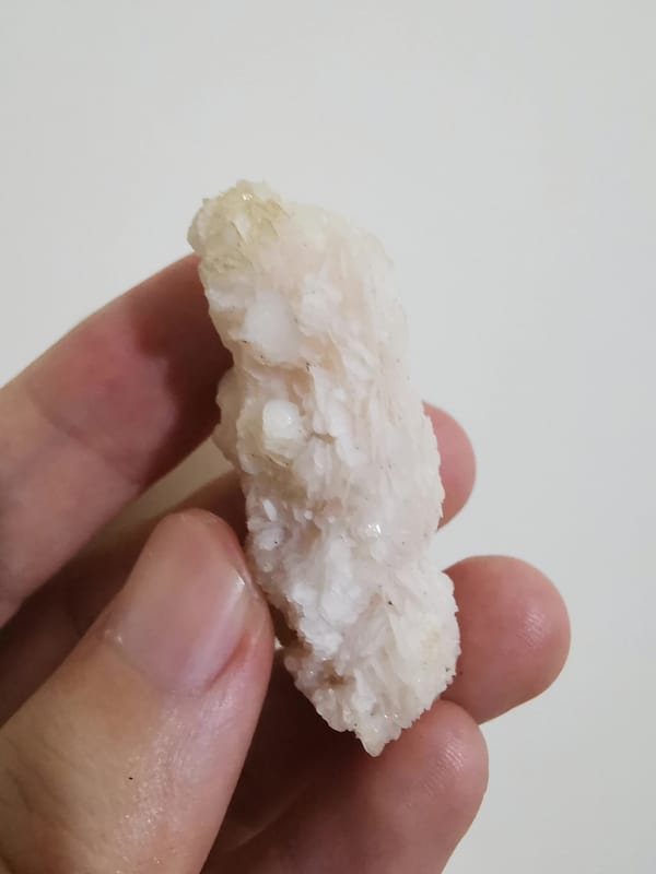 Pale pink calcite floater cluster, oblique view