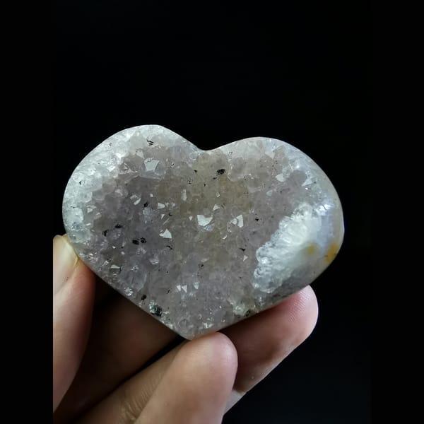 Polished pink-purple quartz heart with black tourmaline — complete view