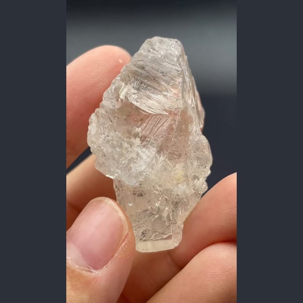 Clear naturally etched topaz crystal from Yunnan — complete view