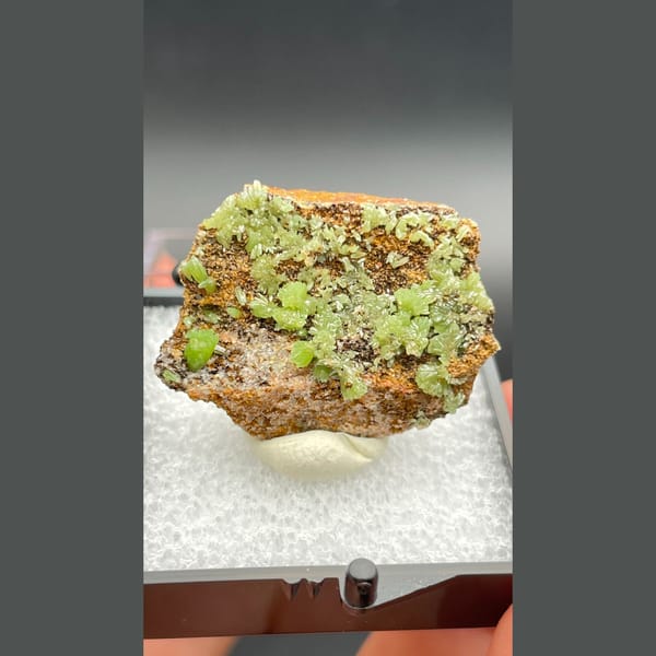 Bright green pyromorphite crystals on brown matrix from Guangxi — detail view