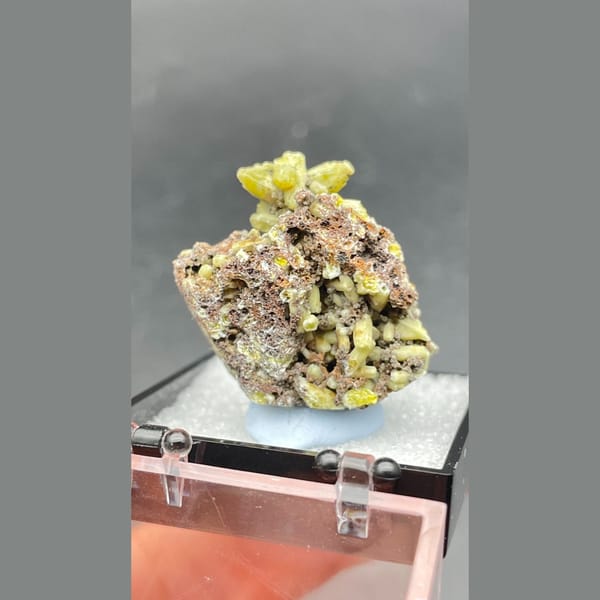 Bright yellow-green plumbogummite on grey-brown matrix from Guangxi — alternate view
