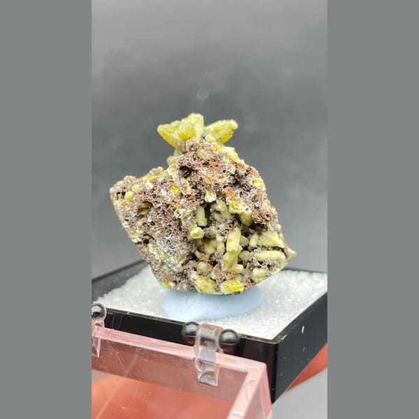 Bright yellow-green plumbogummite on grey-brown matrix from Guangxi — detail view
