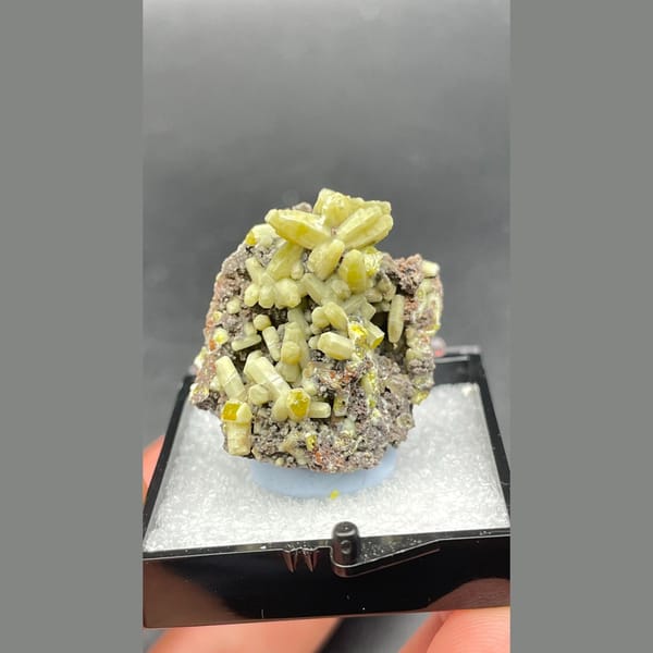 Bright yellow-green plumbogummite on grey-brown matrix from Guangxi — detail view