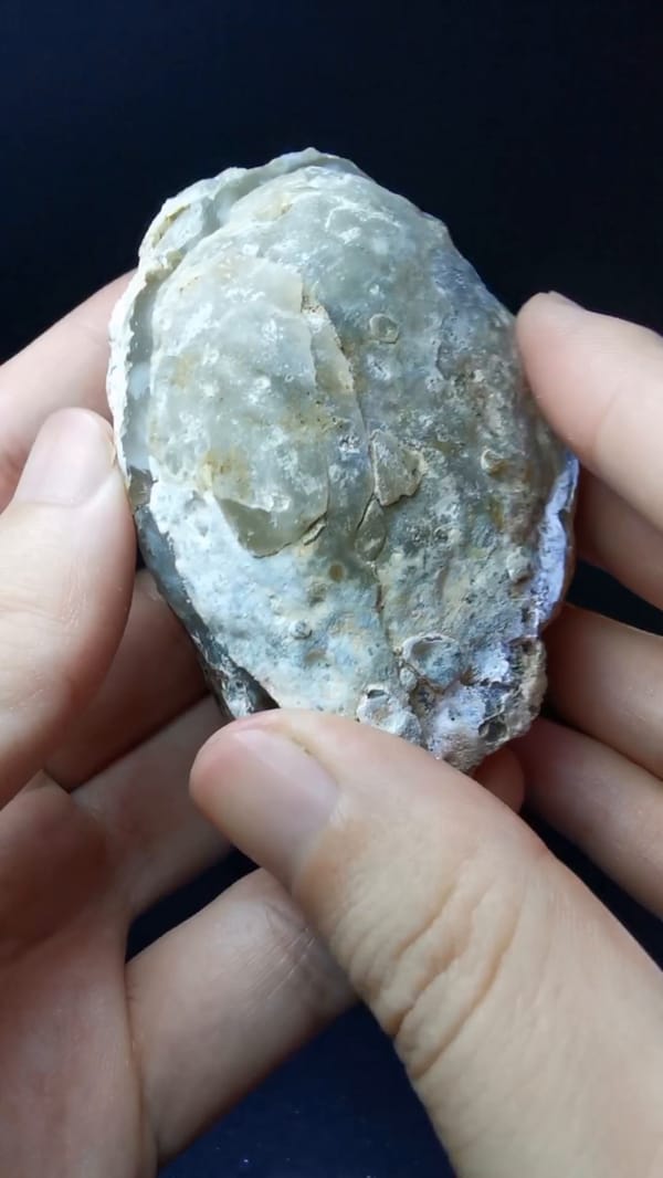 Complete closed exterior view of the same matched Brazilian agate geode pair