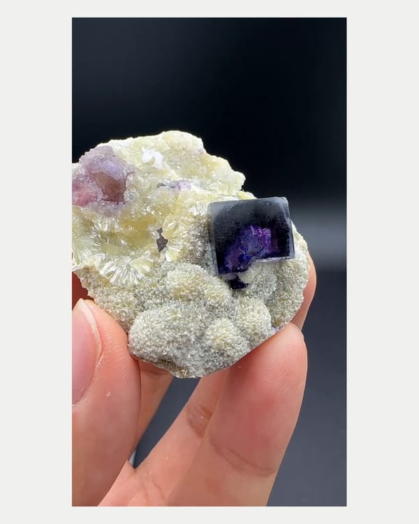 Complete front view of purple phantom fluorite with mica