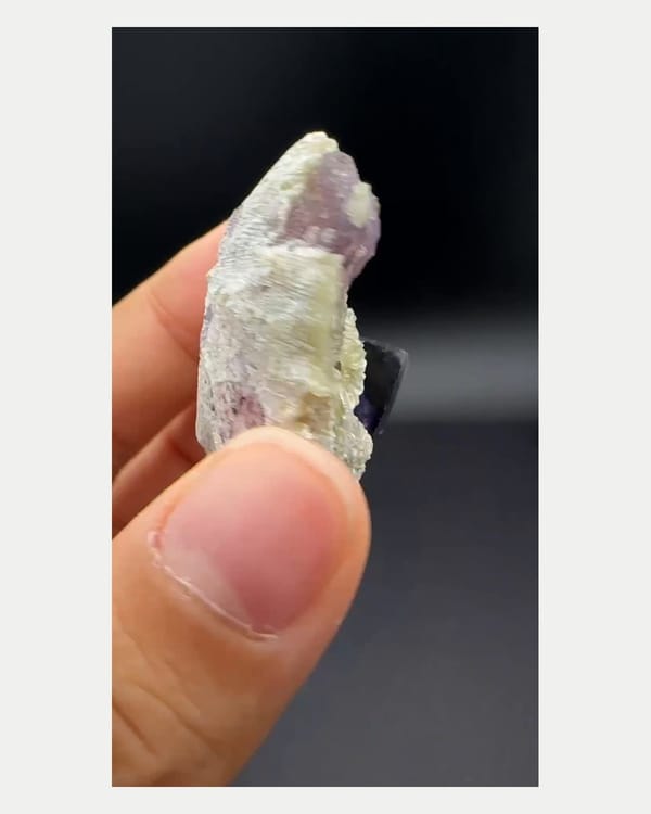 Complete right oblique view of purple phantom fluorite with mica