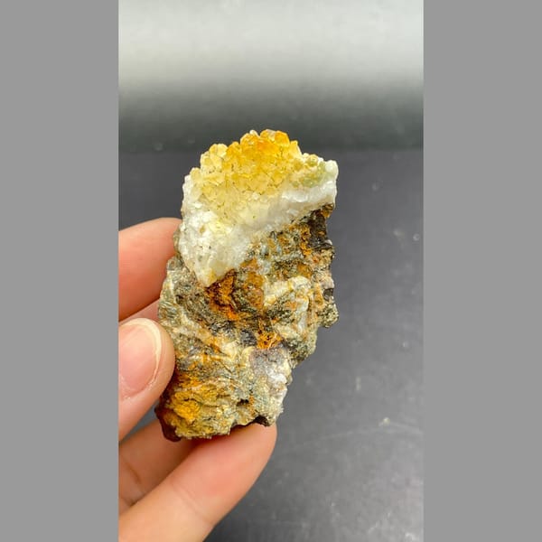 Orange-yellow pyromorphite with white quartz on brown matrix from Guangxi — alternate view