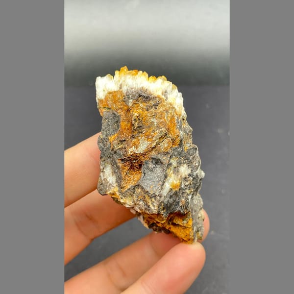 Orange-yellow pyromorphite with white quartz on brown matrix from Guangxi — alternate view