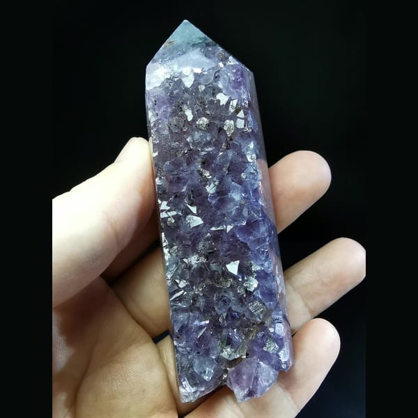 Polished Uruguayan amethyst tower with crystal flowers — complete view