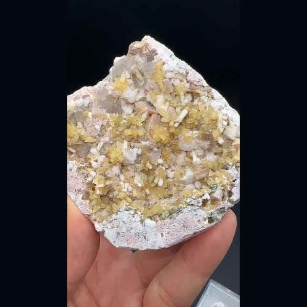 Yellow stilbite sprays with feldspar and quartz on a plate from Yunxiao, Fujian — complete view
